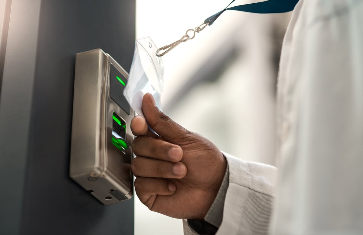 Scientist using access card to gain entry at a door